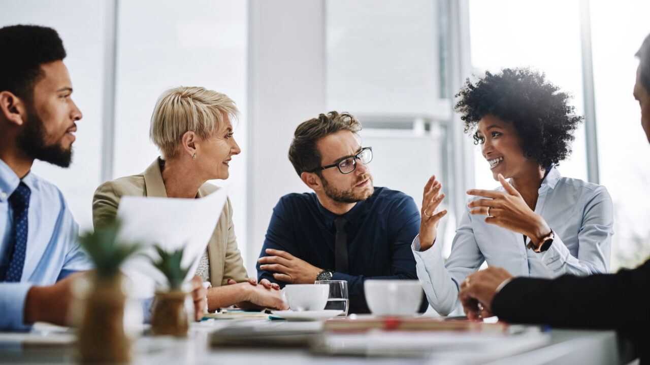 Shot of a group of businesspeople sitting together in a meeting