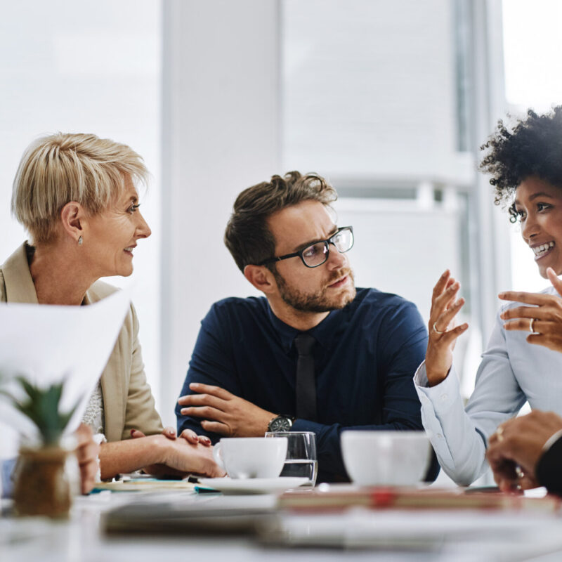Shot of a group of businesspeople sitting together in a meeting
